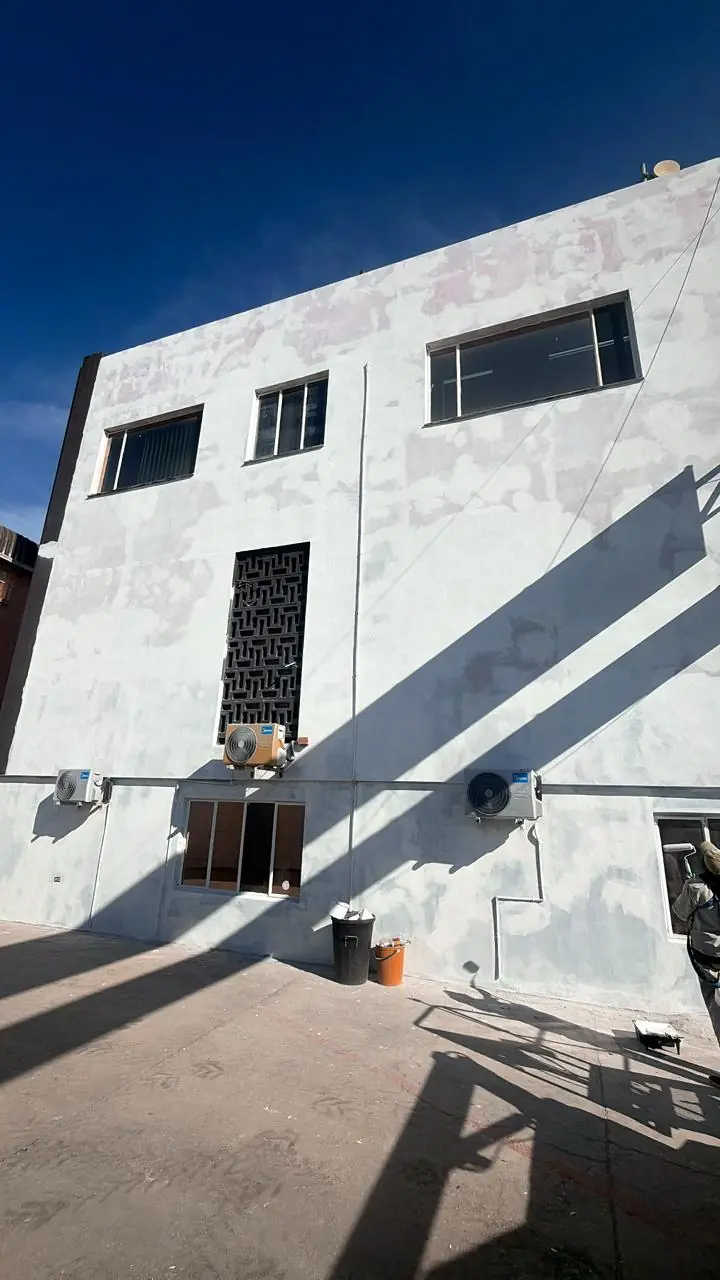 Faded and stripped-back facade of a commercial building on Kempston Road, Gqeberha, during preparation by Under Pressure (1 of 6)